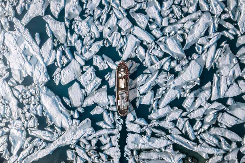 aerial view ship amidst glacier sea